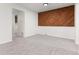 Dining area with seamless carpet, accent wall, and views to laundry room at 7700 W Glasgow Pl # C, Littleton, CO 80128