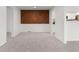 Dining space with accent wood wall and seamless carpet at 7700 W Glasgow Pl # 8C, Littleton, CO 80128