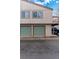 Exterior view of townhome garages with parking and a well-maintained facade at 7700 W Glasgow Pl # 8C, Littleton, CO 80128