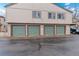 Exterior view of townhome garages with parking and a well-maintained facade at 7700 W Glasgow Pl # 8C, Littleton, CO 80128