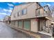 Exterior view of the townhome with carports, garages, and well-kept facade at 7700 W Glasgow Pl # 8C, Littleton, CO 80128