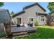 Home exterior view of deck and backyard featuring well-maintained lawn and gray siding at 2629 Wisteria Dr, Erie, CO 80516