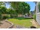 A spacious backyard featuring a well-maintained lawn, a wooden fence, and a cozy deck at 2629 Wisteria Dr, Erie, CO 80516
