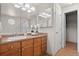 Bathroom vanity with warm wood cabinets, a large mirror, and modern lighting, offering a clean and functional space at 2629 Wisteria Dr, Erie, CO 80516