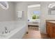 Bright bathroom showcasing a deep soaking tub and a view into the connected bedroom, creating a spa-like ambiance at 2629 Wisteria Dr, Erie, CO 80516