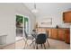 Cozy dining area features tile floors, modern lighting, sliders to outside deck, and stylish furnishings at 2629 Wisteria Dr, Erie, CO 80516