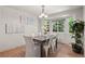 Bright dining room featuring wood floors, a bay window that offers plenty of natural light, and modern decor at 2629 Wisteria Dr, Erie, CO 80516