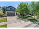 Charming two-story home features a stone facade, gray siding, a two-car garage and a well-manicured lawn at 2629 Wisteria Dr, Erie, CO 80516