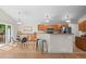 Bright eat-in kitchen features wooden cabinets, stainless steel appliances, breakfast bar, and access to the outdoor deck at 2629 Wisteria Dr, Erie, CO 80516