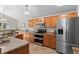 This spacious kitchen features wood cabinets, stainless steel appliances, and tile flooring, perfect for cooking and entertaining at 2629 Wisteria Dr, Erie, CO 80516