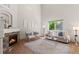 Bright living room boasts a stone fireplace, plush seating, and a large window at 2629 Wisteria Dr, Erie, CO 80516