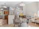 Open-concept living space featuring a kitchen, dining area, living room and fireplace at 2629 Wisteria Dr, Erie, CO 80516