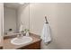 Cozy powder room featuring a pedestal sink with updated fixtures and a decorative mirror, maximizing space and style at 2629 Wisteria Dr, Erie, CO 80516