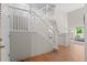 Elegant staircase with white railings and wood floors leading to the upper level at 2629 Wisteria Dr, Erie, CO 80516