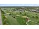 Expansive aerial view of a meticulously maintained golf course surrounded by trees and a clubhouse at 2945 E 26Th Avenue Pkwy, Denver, CO 80205