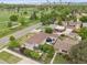Aerial view of a charming home with lush landscaping, golf course nearby, and city skyline in background at 2945 E 26Th Avenue Pkwy, Denver, CO 80205
