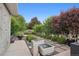 Serene backyard featuring lush landscaping, a decorative water feature, and a cozy seating area at 2945 E 26Th Avenue Pkwy, Denver, CO 80205