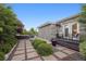 Landscaped backyard patio features a stone walkway, lush greenery, and an outdoor seating area at 2945 E 26Th Avenue Pkwy, Denver, CO 80205