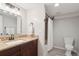 Updated bathroom featuring wood vanity, granite countertops, and shower-tub combo at 2945 E 26Th Avenue Pkwy, Denver, CO 80205