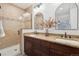 Bathroom features a double sink vanity, decorative mirrors, and a tiled walk-in shower at 2945 E 26Th Avenue Pkwy, Denver, CO 80205
