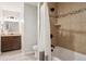 Bathroom with tub and shower features a tile surround, vanity with granite top, and decorative mirror at 2945 E 26Th Avenue Pkwy, Denver, CO 80205