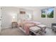 Bright bedroom boasts natural light, neutral tones, two ottomans, and a comfy bed at 2945 E 26Th Avenue Pkwy, Denver, CO 80205