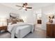 Bright bedroom features a ceiling fan, neutral color palette, carpet floors, and a connecting bathroom at 2945 E 26Th Avenue Pkwy, Denver, CO 80205