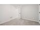A simple bedroom with light gray carpet, white walls and trim at 2945 E 26Th Avenue Pkwy, Denver, CO 80205