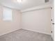 Minimalist bedroom with neutral walls, carpet, and ample natural light from a window at 2945 E 26Th Avenue Pkwy, Denver, CO 80205