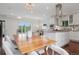 Bright dining area with a modern kitchen island, stainless steel appliances, and a view of the living room at 2945 E 26Th Avenue Pkwy, Denver, CO 80205