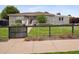 Charming gray brick home with well-manicured lawn, inviting front porch, and a decorative sunflower wreath at 2945 E 26Th Avenue Pkwy, Denver, CO 80205