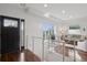 Bright, airy foyer with modern railings, hardwood floors, and a view into the living room at 2945 E 26Th Avenue Pkwy, Denver, CO 80205