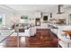 Bright, open-concept living room and kitchen area with stainless steel appliances and hardwood floors at 2945 E 26Th Avenue Pkwy, Denver, CO 80205
