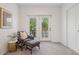 Cozy sitting area with a chair and ottoman next to the french doors overlooking the balcony at 2945 E 26Th Avenue Pkwy, Denver, CO 80205