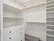 Walk-in closet with built-in shelving and drawers, and a wooden clothes rod at 2945 E 26Th Avenue Pkwy, Denver, CO 80205
