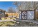 A backyard shed and garden boxes behind a wood fence at 3164 S Forest St, Denver, CO 80222