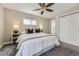 Bright main bedroom with soft carpet, ceiling fan, and ensuite bathroom with walk in closet at 3164 S Forest St, Denver, CO 80222