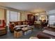 Living room with brown leather furniture and a dining area at 6495 E Happy Canyon Rd # 88, Denver, CO 80237