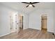 Spacious bedroom with a ceiling fan, large closet, and hardwood floors at 8362 White Cloud St, Highlands Ranch, CO 80126