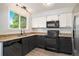 Modern kitchen with dark cabinets and granite countertops at 8362 White Cloud St, Highlands Ranch, CO 80126