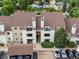 Birds-eye view of a multi-Gathering building with brown roofs, well-kept landscaping, and a parking area at 7379 S Gore Range Rd # 304, Littleton, CO 80127