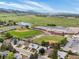 Stunning aerial view of neighborhood featuring a school with green sports fields, mountain views and homes at 7379 S Gore Range Rd # 304, Littleton, CO 80127