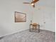 Bright bedroom with a ceiling fan, neutral carpet, and versatile workspace with desk at 7379 S Gore Range Rd # 304, Littleton, CO 80127