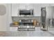 Stylish kitchen featuring stainless steel appliances, granite countertops, and ample cabinet space at 7379 S Gore Range Rd # 304, Littleton, CO 80127