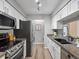 Updated kitchen featuring white cabinets, stainless steel appliances, and granite countertops at 7379 S Gore Range Rd # 304, Littleton, CO 80127