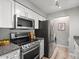 Modern kitchen featuring stainless steel appliances, granite countertops, and bright cabinetry at 7379 S Gore Range Rd # 304, Littleton, CO 80127