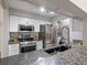Modern kitchen featuring stainless steel appliances, granite countertops, and in-unit laundry at 7379 S Gore Range Rd # 304, Littleton, CO 80127