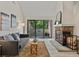 Bright living room with vaulted ceiling, fireplace, balcony, and modern neutral decor at 7379 S Gore Range Rd # 304, Littleton, CO 80127