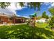 Spacious backyard featuring a large lawn, covered patio area, and a wooden playset for  at 428 W Valleyview Ave, Littleton, CO 80120