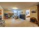 Finished basement with open layout, plush seating, storage and access to another room at 428 W Valleyview Ave, Littleton, CO 80120
